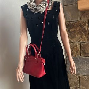 Saki red leather handbag with cross body strap by Greek designer Saki